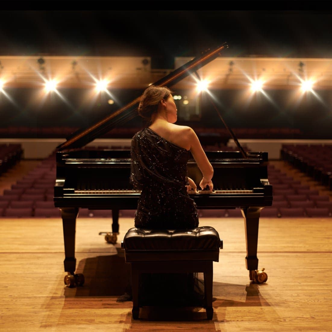 Illustrative pianist performing in a concert setting